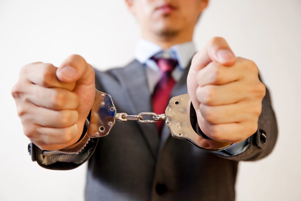 Business man criminal handcuffed