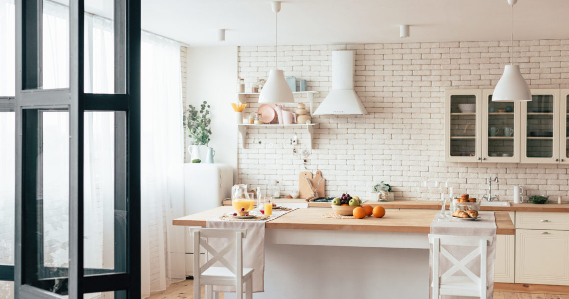 cozy modern kitchen with served table and chairs